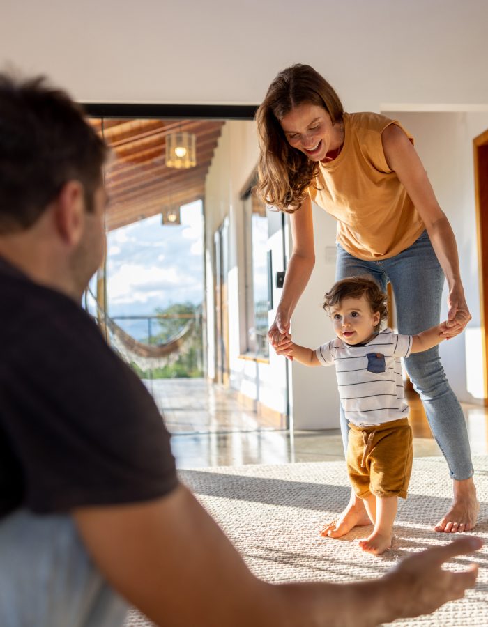 A happy family plays in a living room.